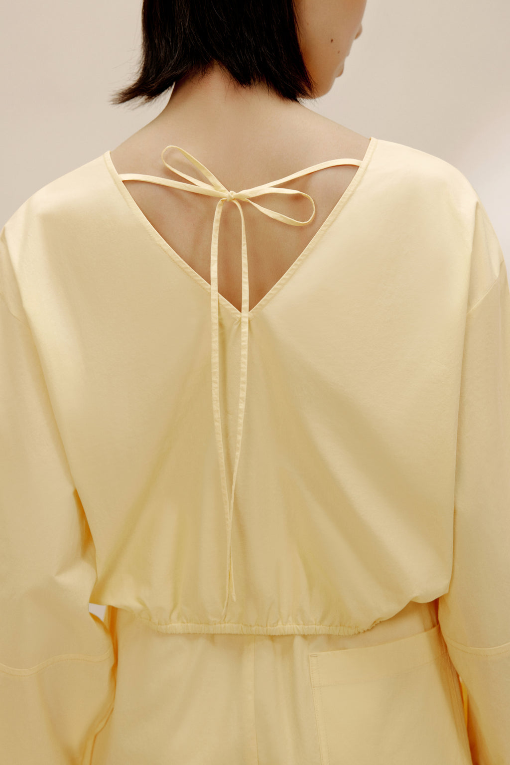 Back view of woman in yellow top.