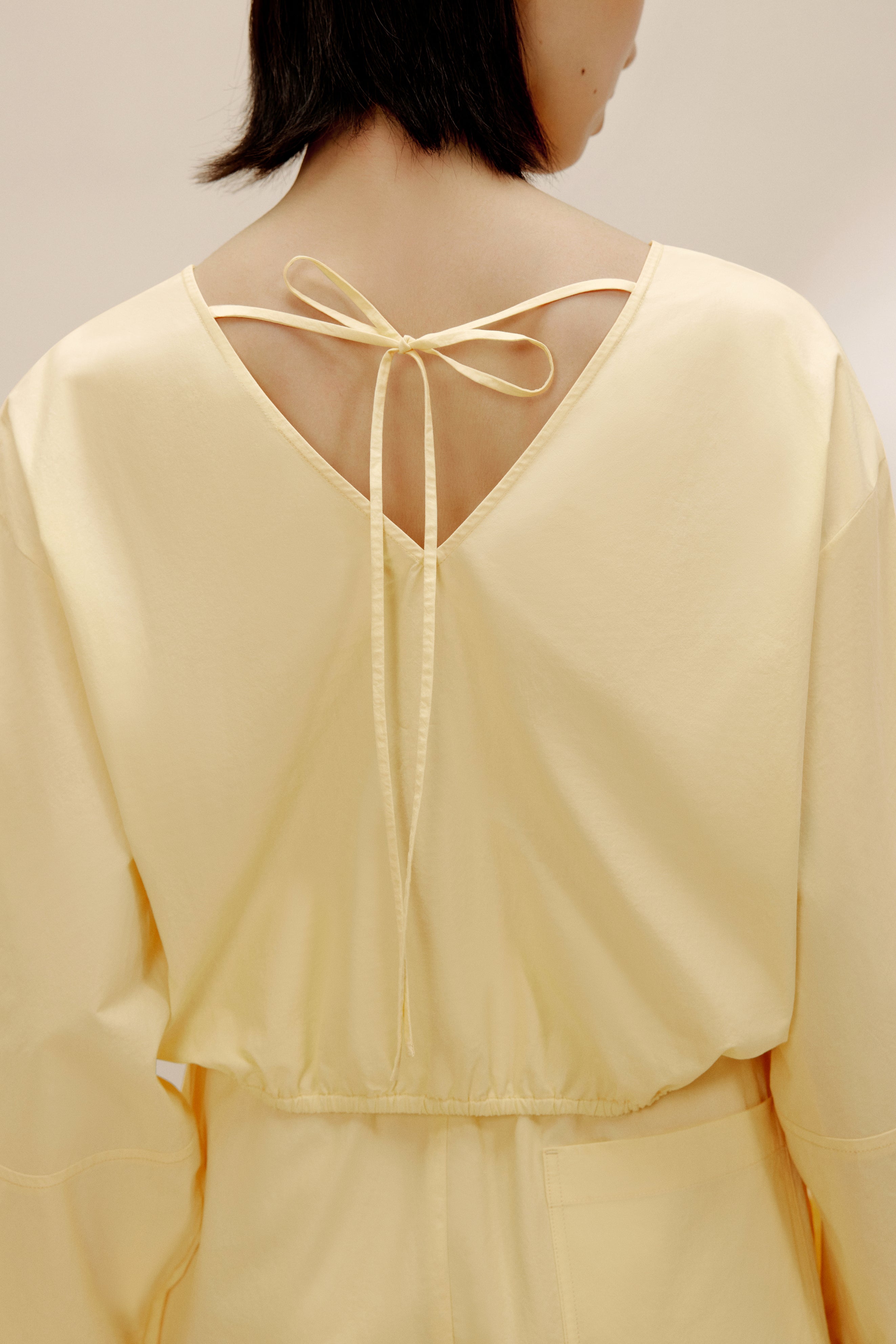 Back view of woman in yellow top.
