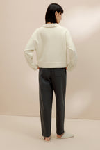 back of women in the white polo shirt and pants