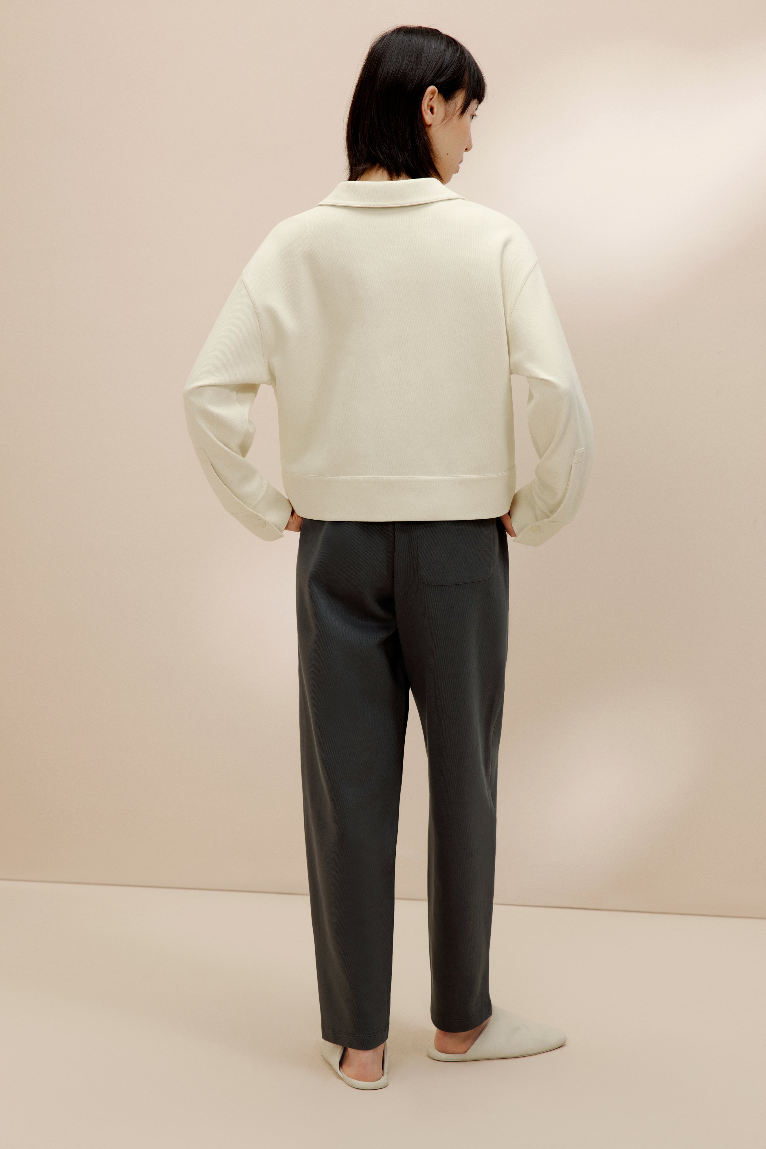 back of women in the white polo shirt and pants