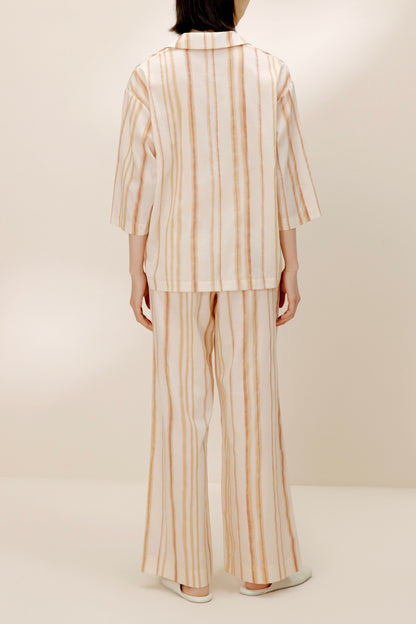 Back view of woman wearing striped top.