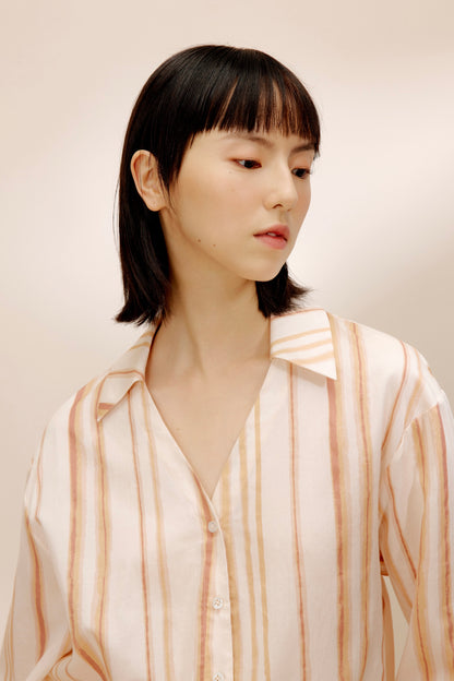Close-up view of woman wearing striped top.