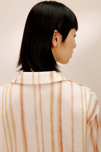 Close-up back view of woman wearing striped top.