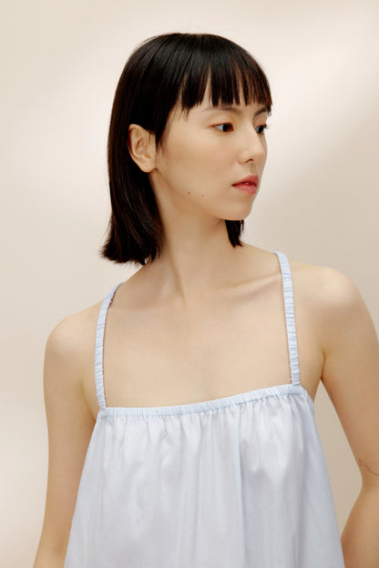 Front view of light blue pajama dress showing elastic details.