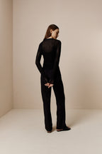 back of women in black Knitted Cardigan and black pants
