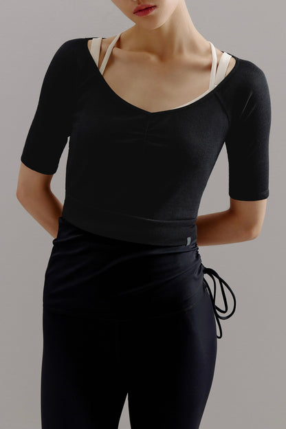 Woman wearing V-neck black sweater.