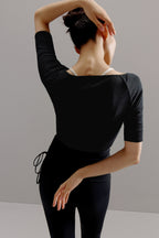 Back view of woman wearing black sweater.