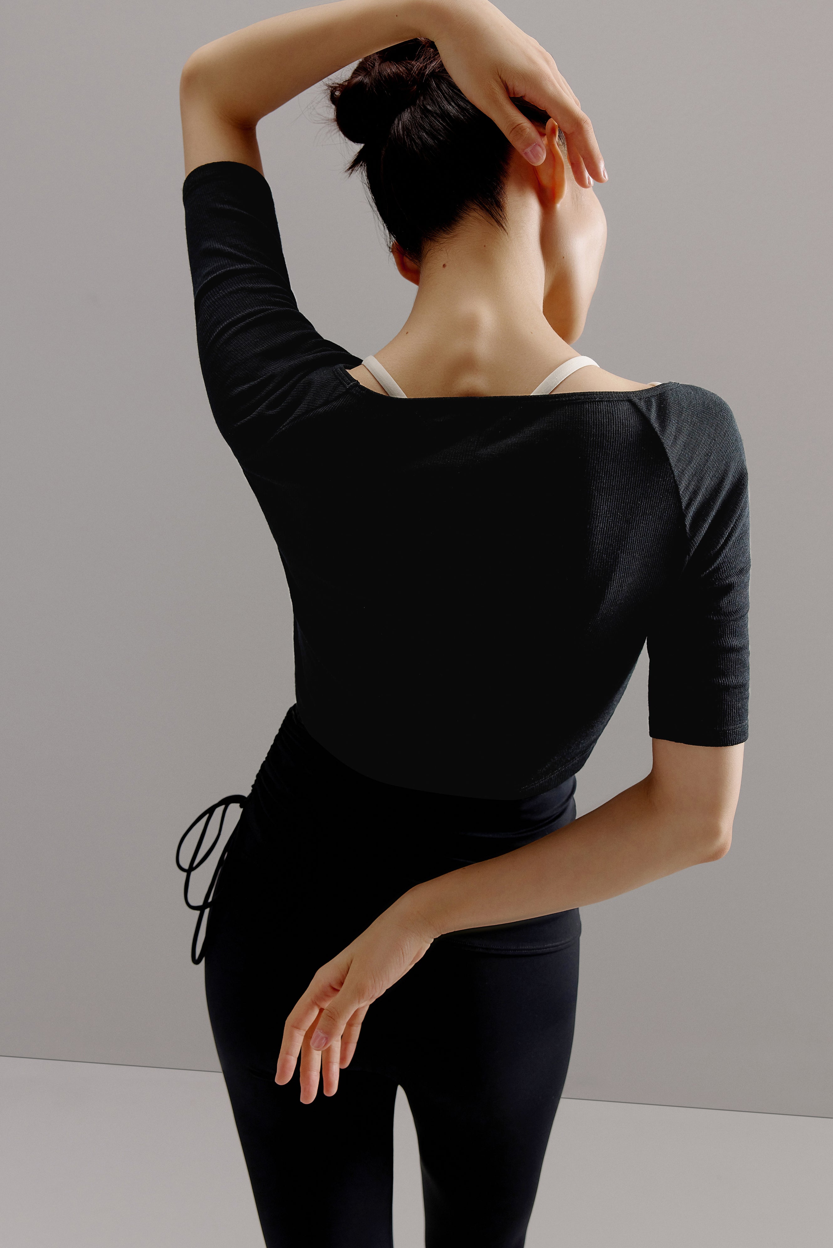 Back view of woman wearing black sweater.
