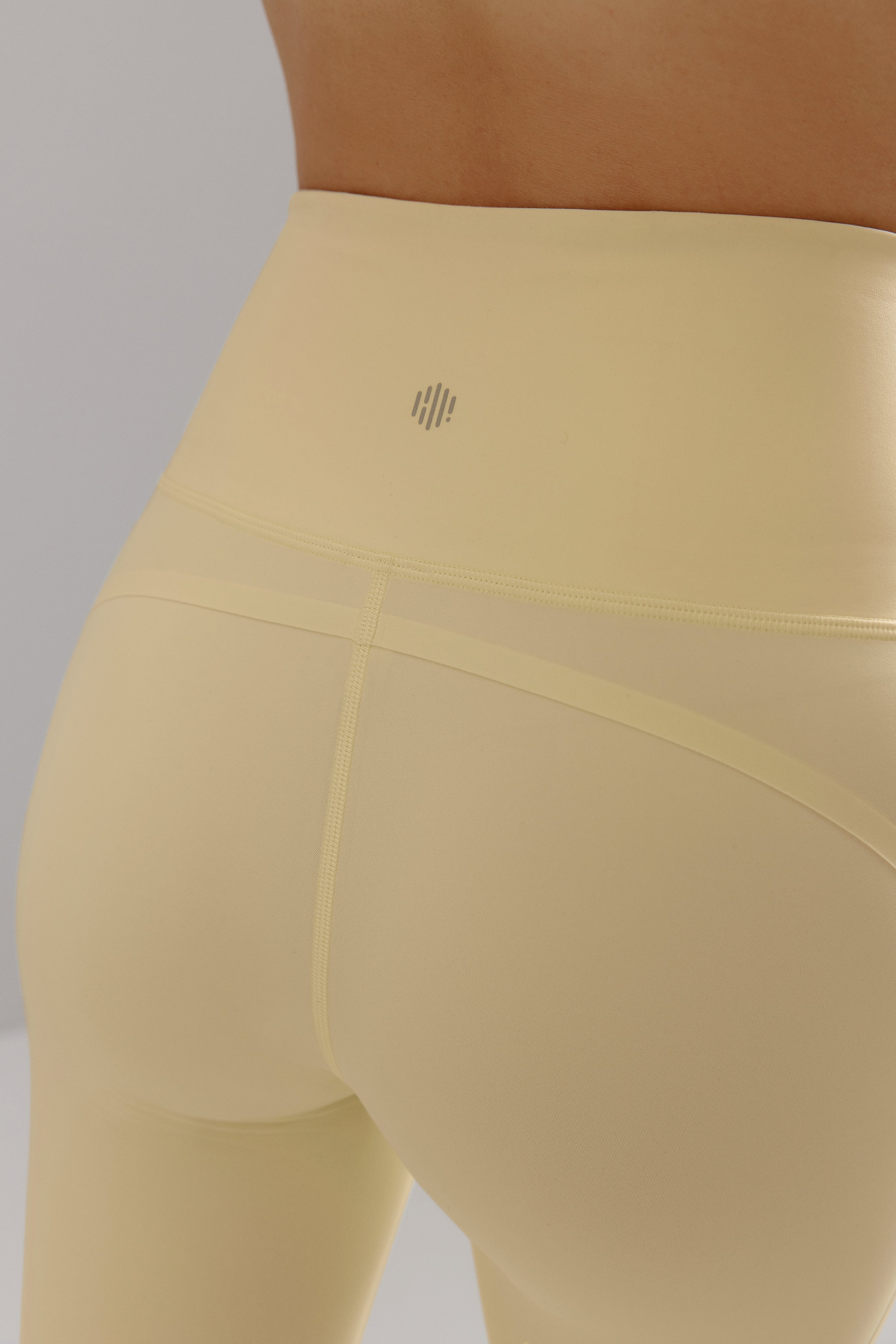 Closeup of back of yellow legging waistband