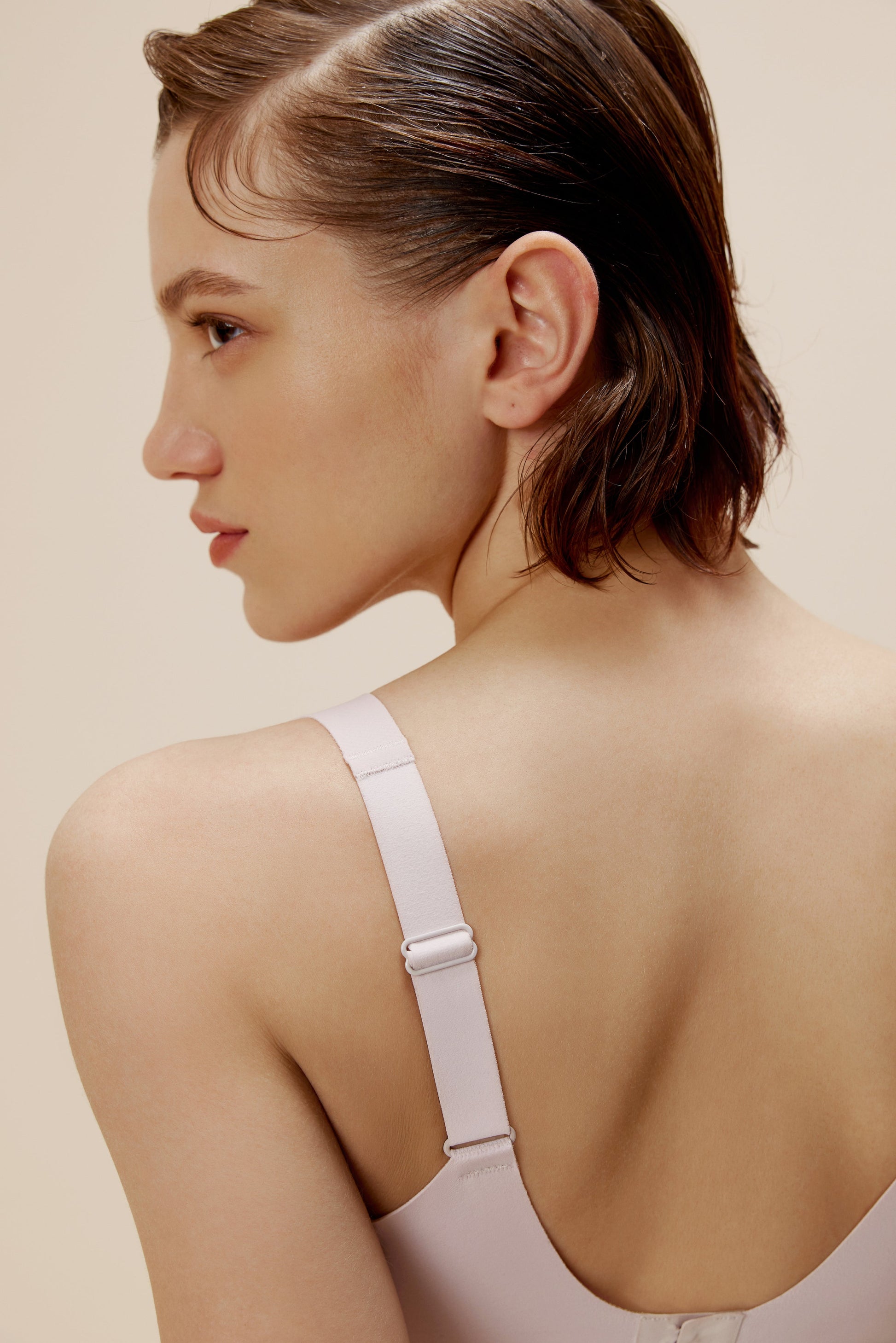 back of woman in off white bra