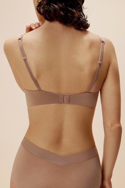 back of woman in tan bra and brief