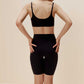 back of woman in black color bra with wavy rim details and black biker shorts