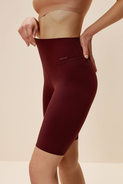 Woman wearing dark red biker shorts