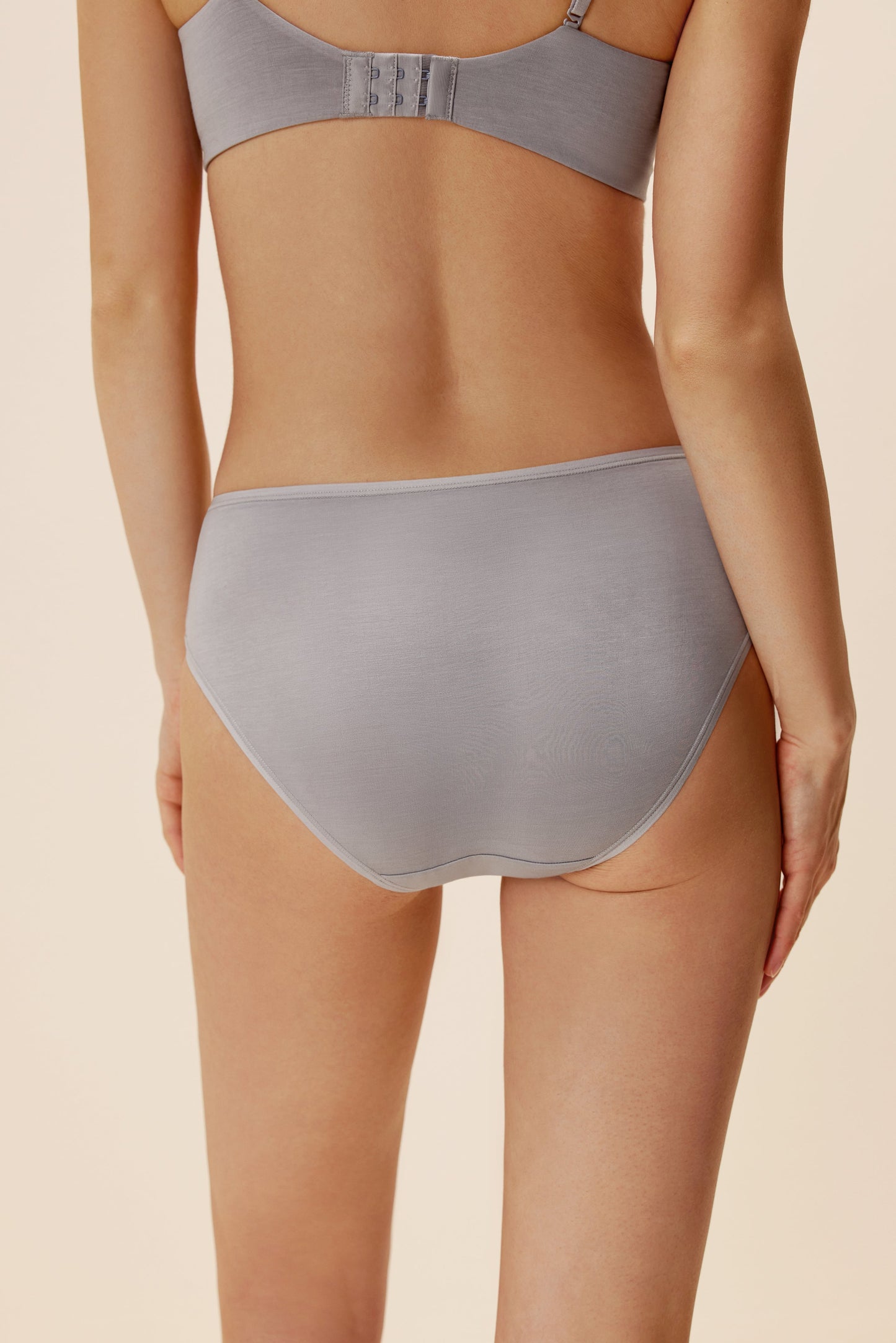 back of woman in lavender brief