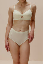 woman in light yellow bra and brief