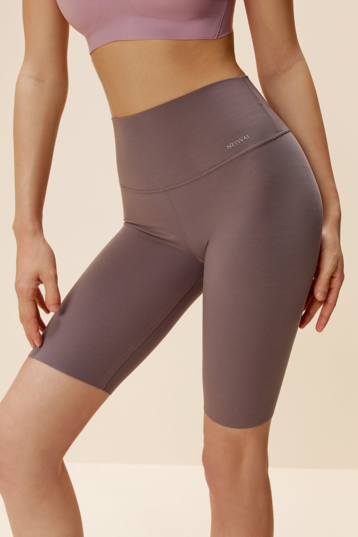 woman wearing light purple biker shorts. Red Bean color.