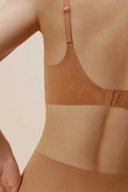 The back of woman wearing caramel bra