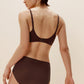 back of woman in brown bra and brief