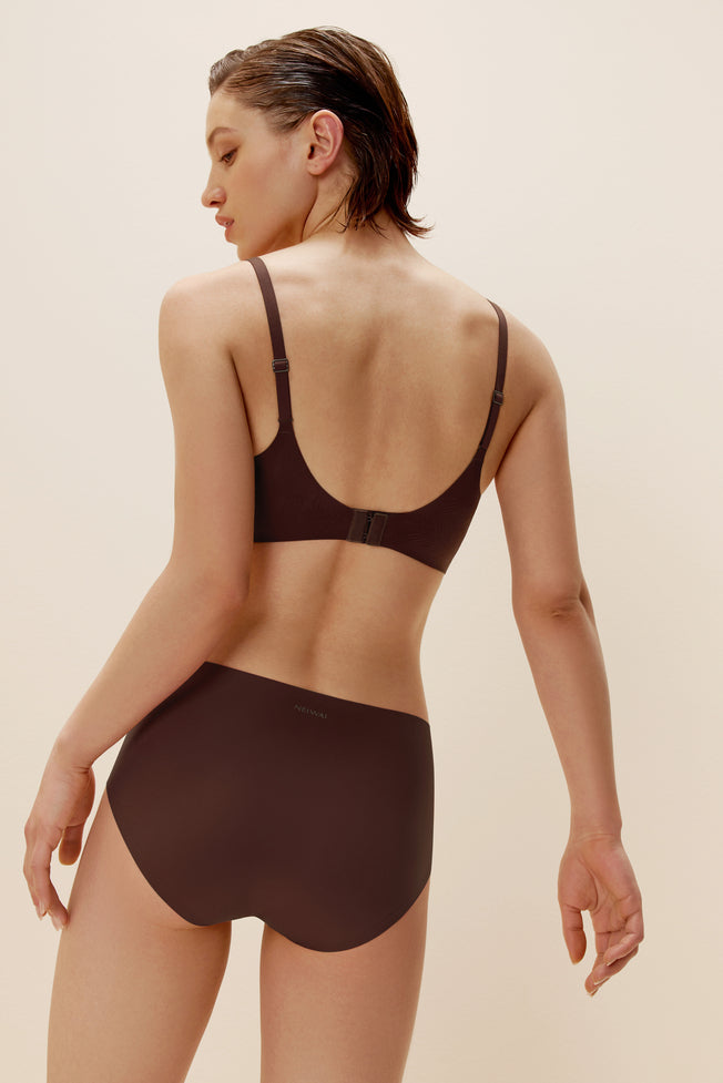 back of woman in brown bra and brief