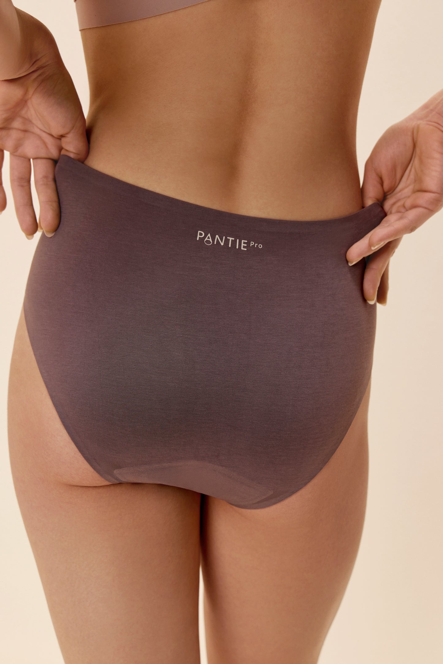 a purple mid waist period brief from back