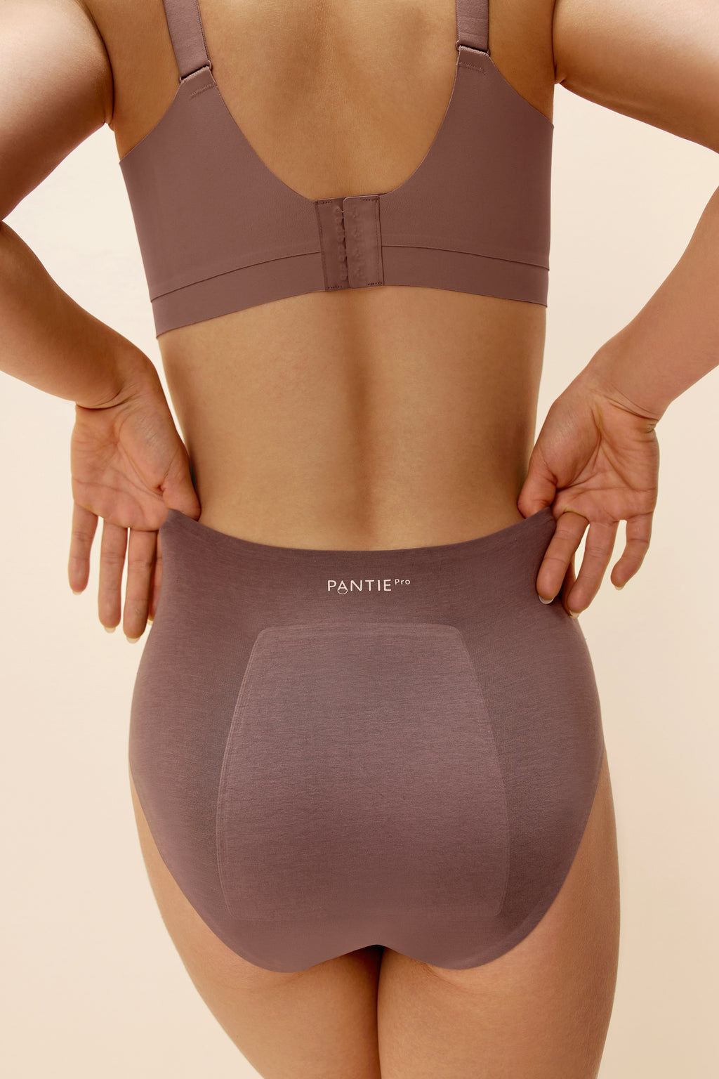 back of woman in woman in purple bra and underwear