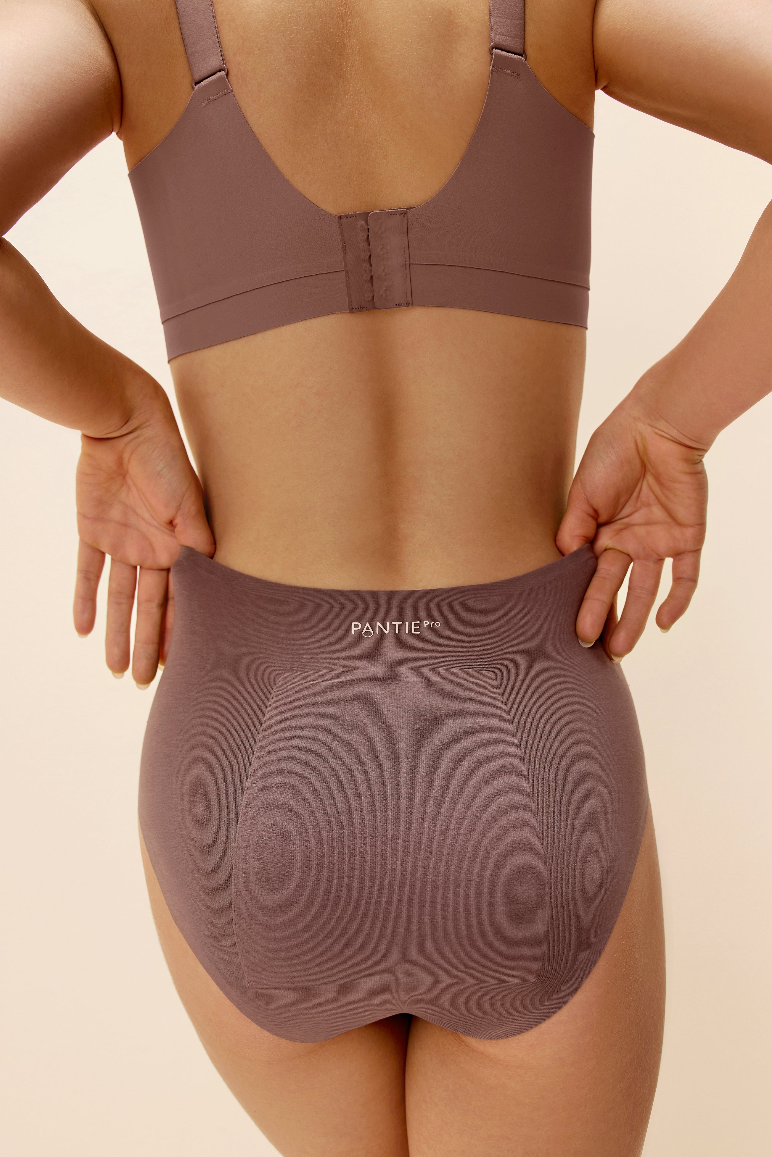 back of woman in woman in purple bra and underwear
