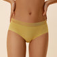 A woman wears a yellow bra and brief.