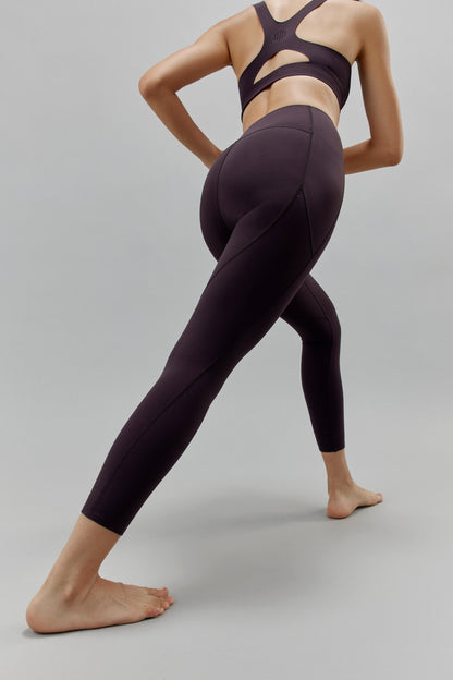 Back of woman wearing black leggings and matching sports bra