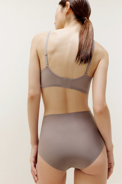 back of woman in purple bra and brief