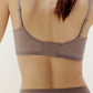 Back view of woman wearing purple grey bra and matching briefs