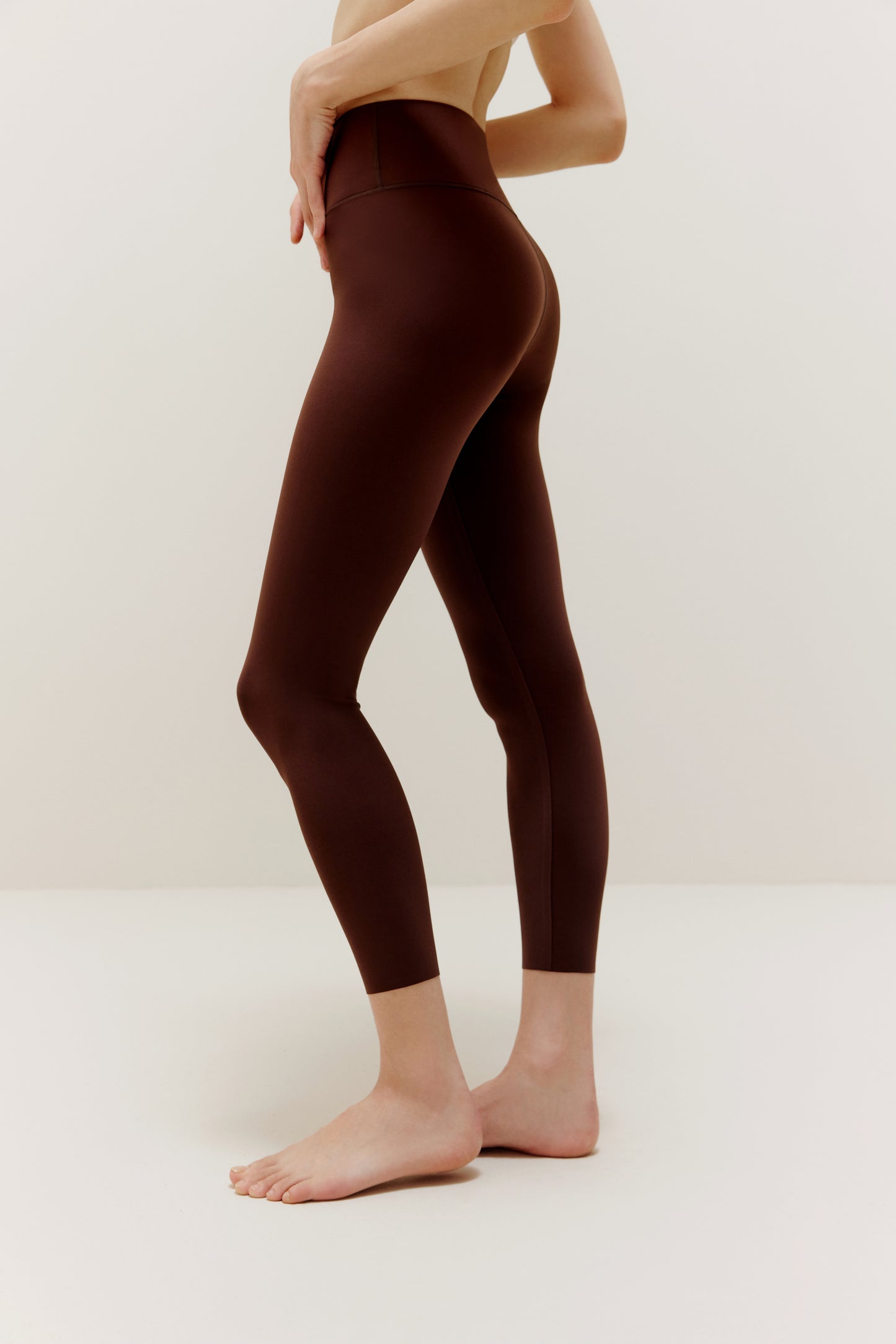 Side view of woman wearing brown leggings