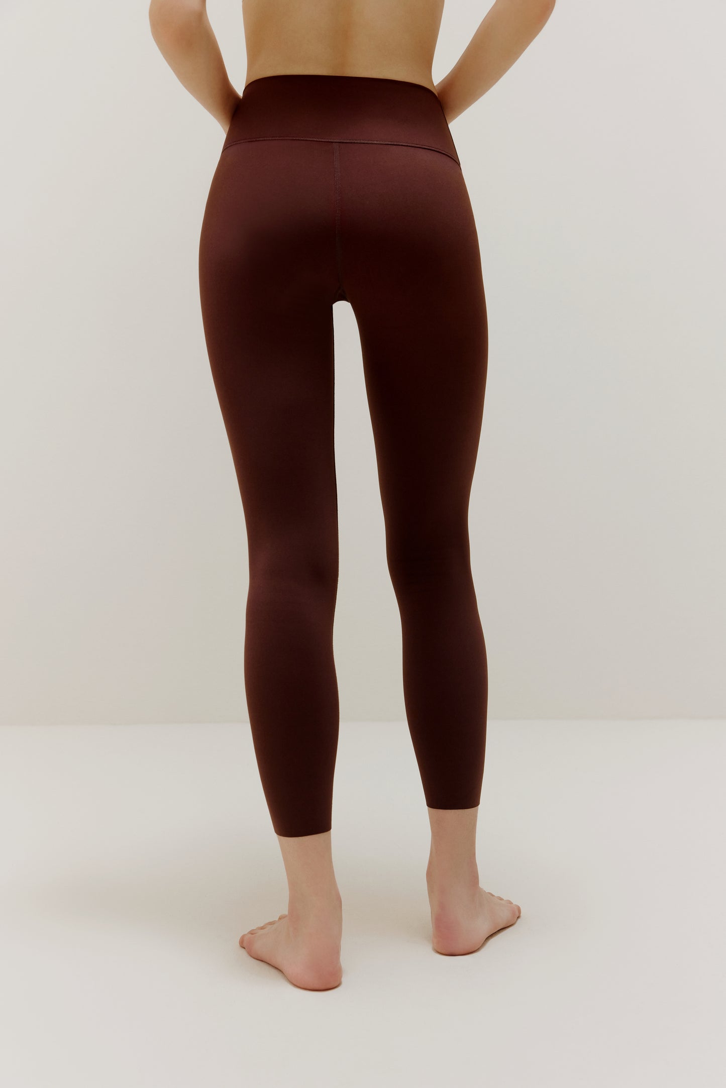 Back view of woman wearing brown leggings
