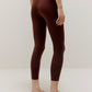 Back side view of woman wearing brown leggings
