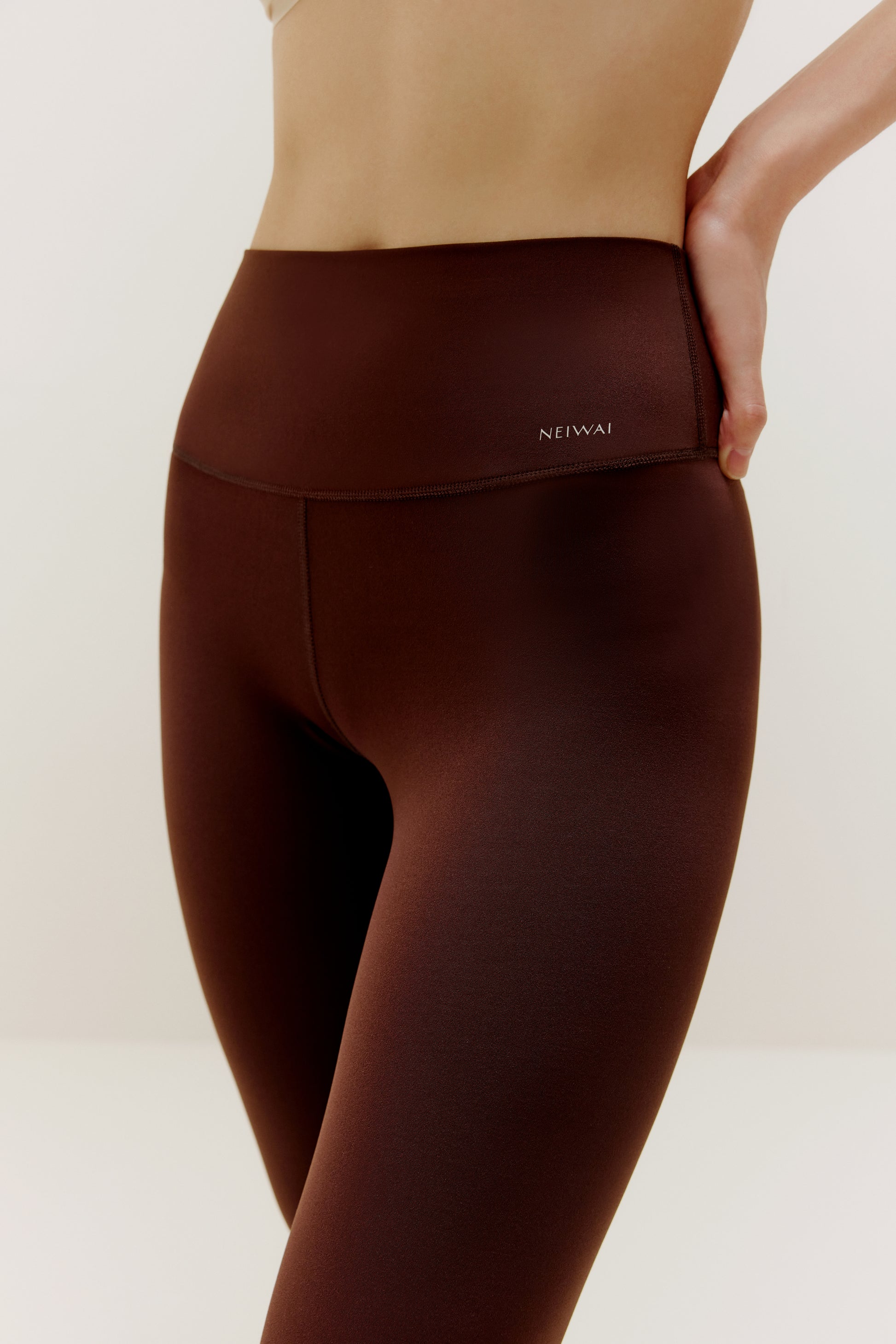 Close up waist band of woman wearing brown leggings
