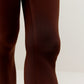 Close up of knee of woman wearing brown leggings