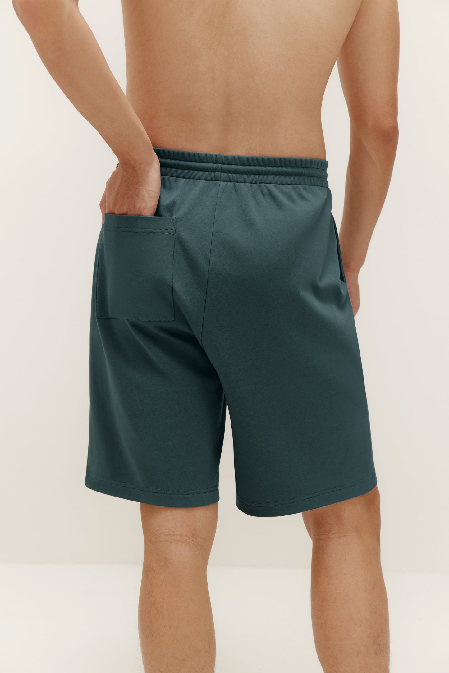 back of man in green shorts