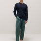 man in navy sweater and green pants