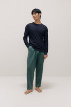man in navy sweater and green pants