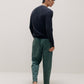 back of man in navy sweater and green pants