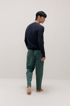 back of man in navy sweater and green pants