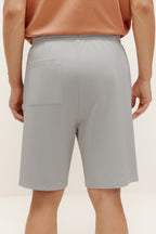 back of man in grey shorts