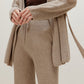 close up of woman in knitted brown cardigan and pants