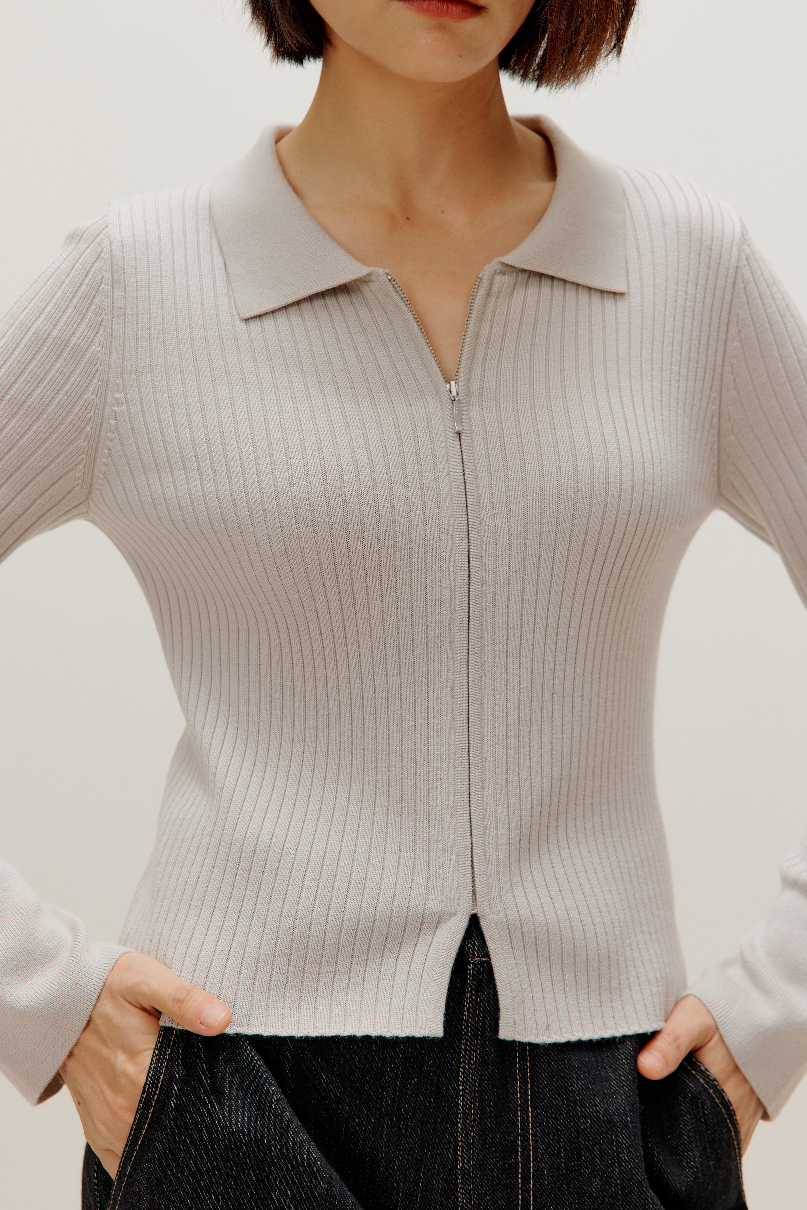 close up of a gray silky wool zip-up cardigan