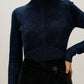 woman wearing blue shimmer mock neck sweater