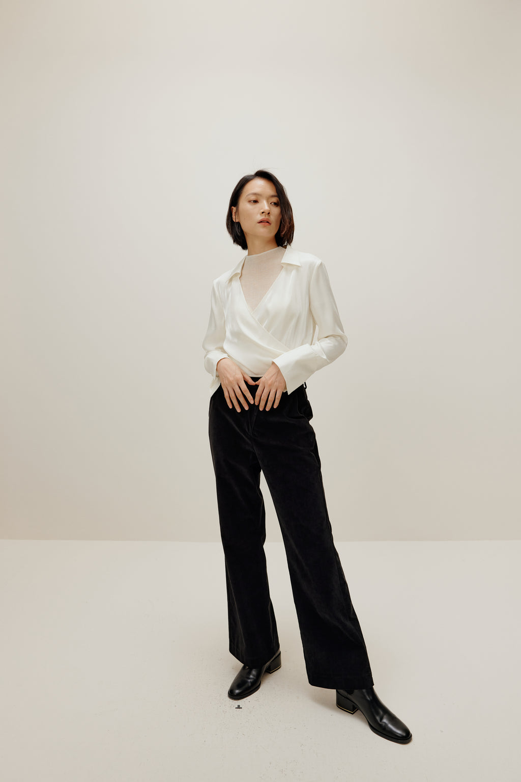 woman in white satin shirt and black bottoms