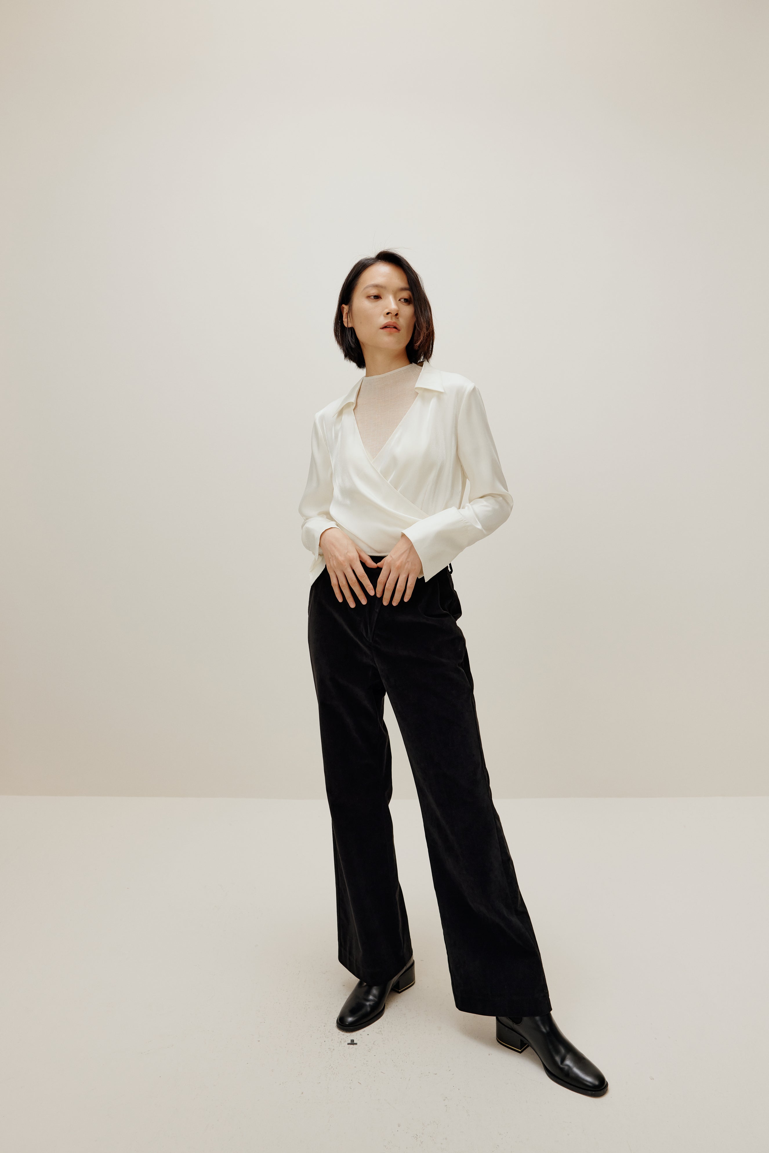 woman in white satin shirt and black bottoms