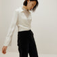 woman in white satin shirt and black bottoms