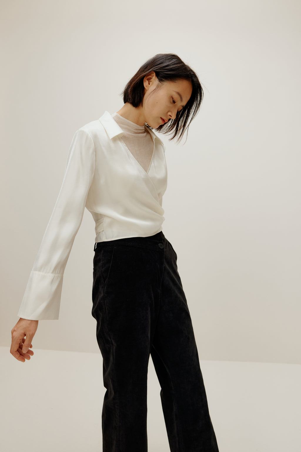 woman in white satin shirt and black bottoms