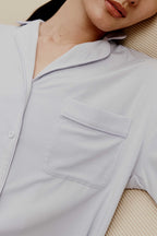 a woman wearing a light blue pajama top