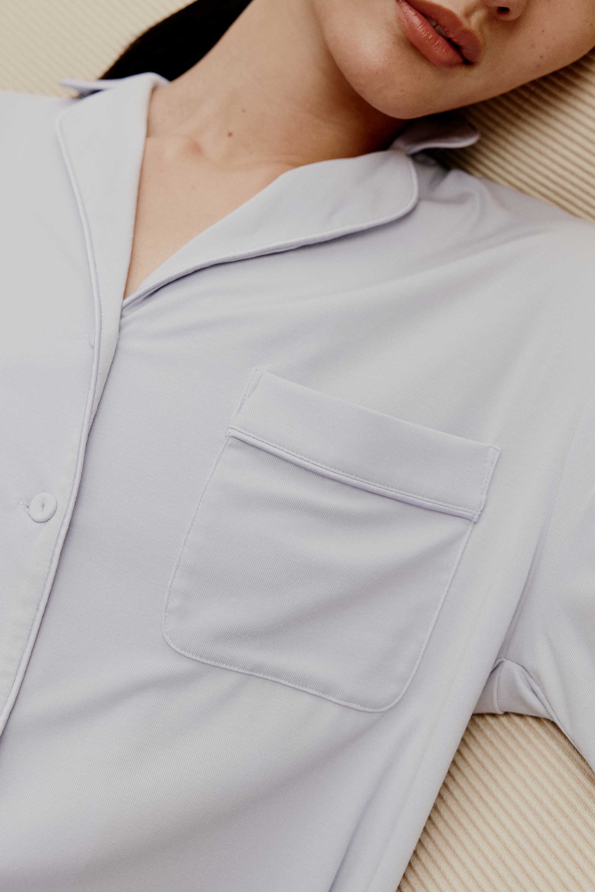 a woman wearing a light blue pajama top